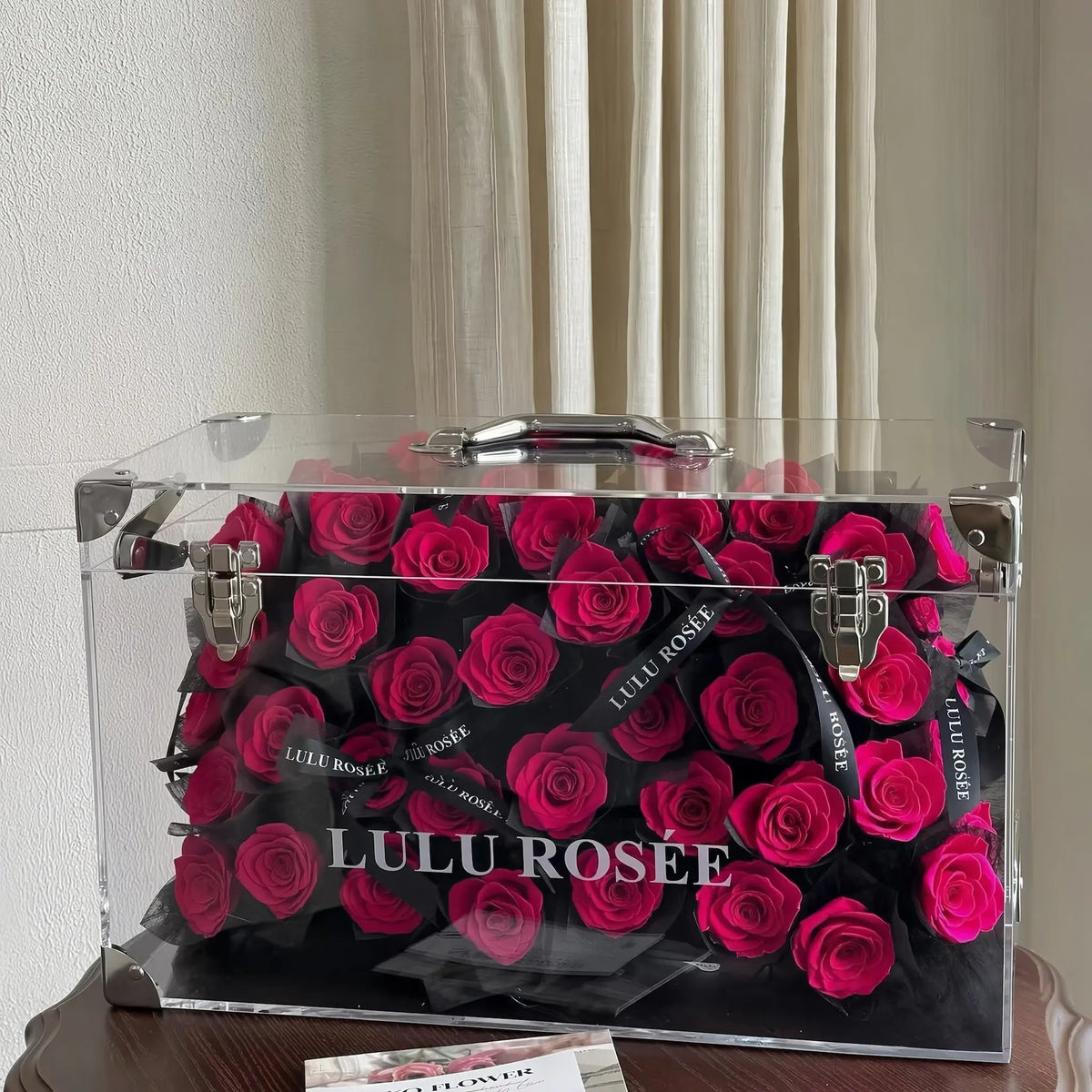 LULU ROSÉE Grande Eternal Acrylic Handbag Rose Box, luxury handbag-shaped transparent acrylic gift box filled with rosy preserved roses, elegant indoor background shot, customizable flower colors, romantic everlasting floral souvenir for anniversary & birthday gifting