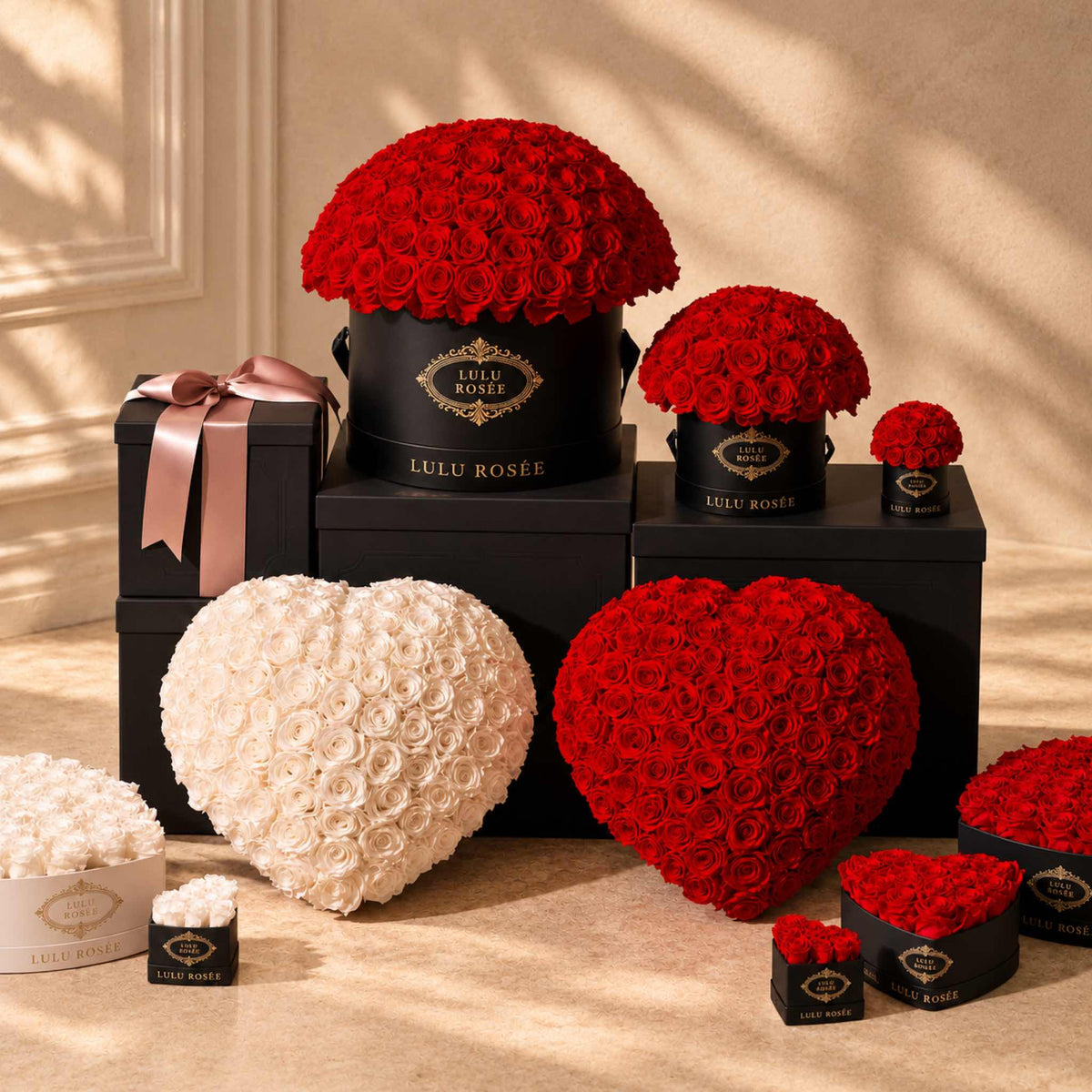 LULU ROSÉE Large Le Plein preserved rose arrangements shown with complementary gift-box sizes in a warm interior.