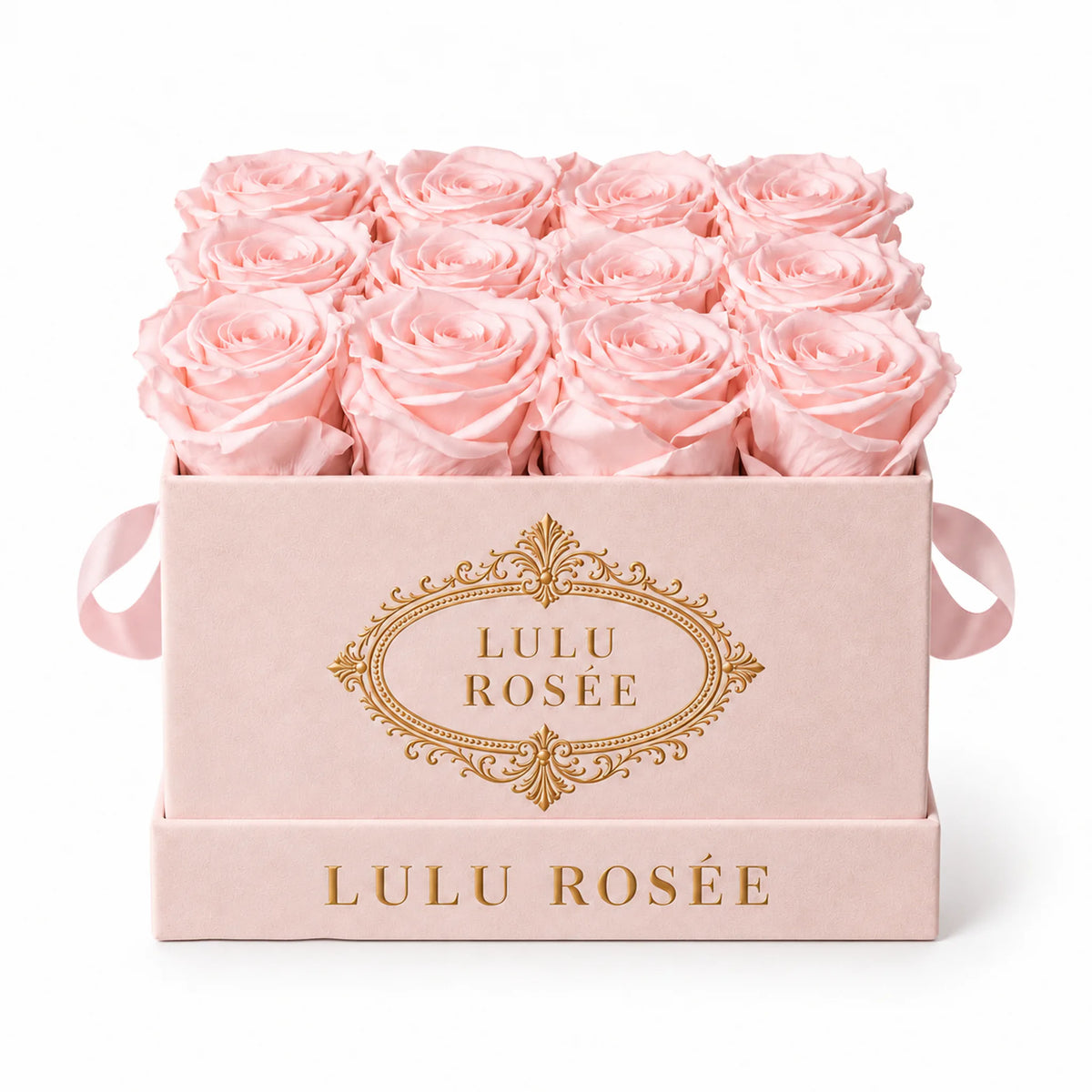 Blush pink preserved roses in a blush suede LULU ROSÉE medium square box on a white background.