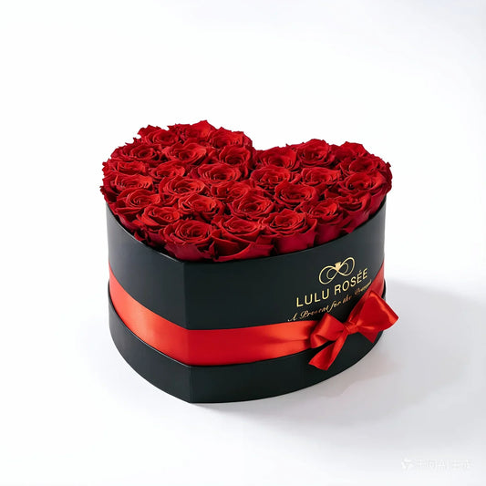 Red preserved roses in a black Large Heart Box.