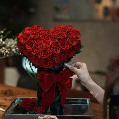 LULU ROSÉE Eternal Rose Garden Heart Bouquet, Hand Adjusting Red Ribbon on 3D Red Rose Arrangement
