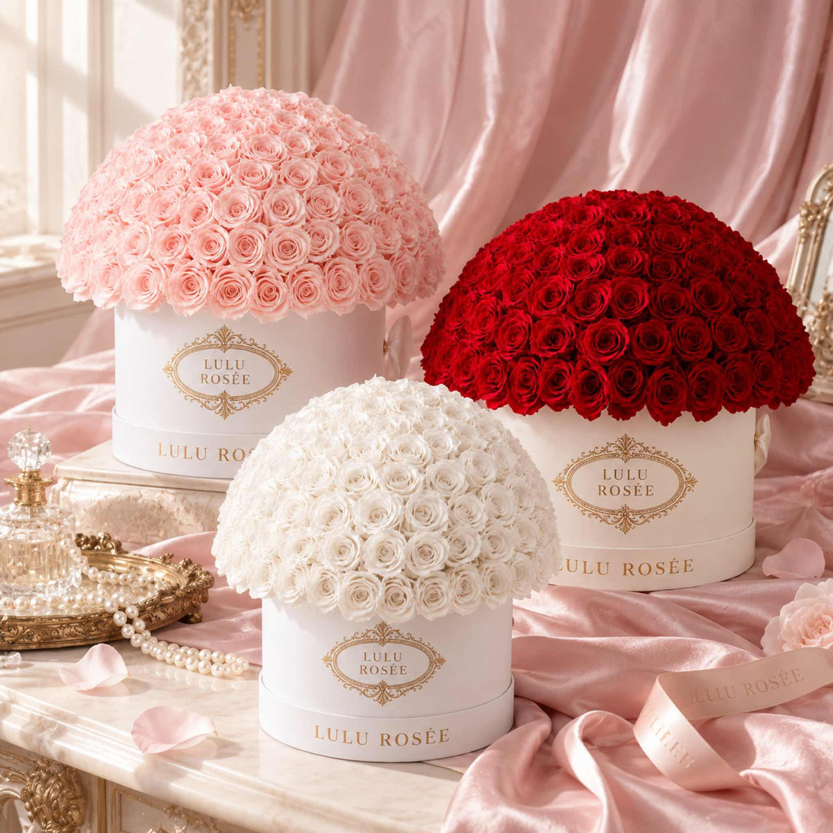 LULU ROSÉE Large Le Plein preserved rose arrangements styled with blush silk in a luxury floral still life.