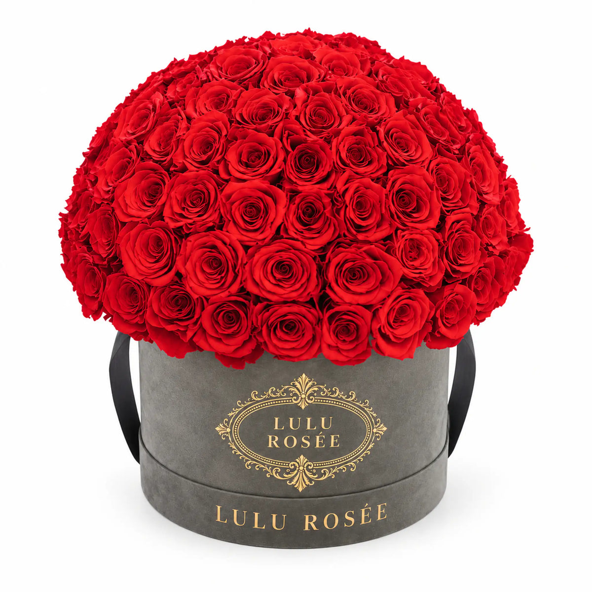 Red preserved roses in a grey suede LULU ROSÉE Large Le Plein box on a white background.