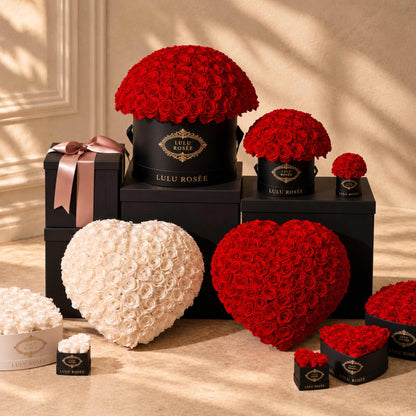 LULU ROSÉE Large Le Plein preserved rose arrangements shown with complementary gift-box sizes in a warm interior.