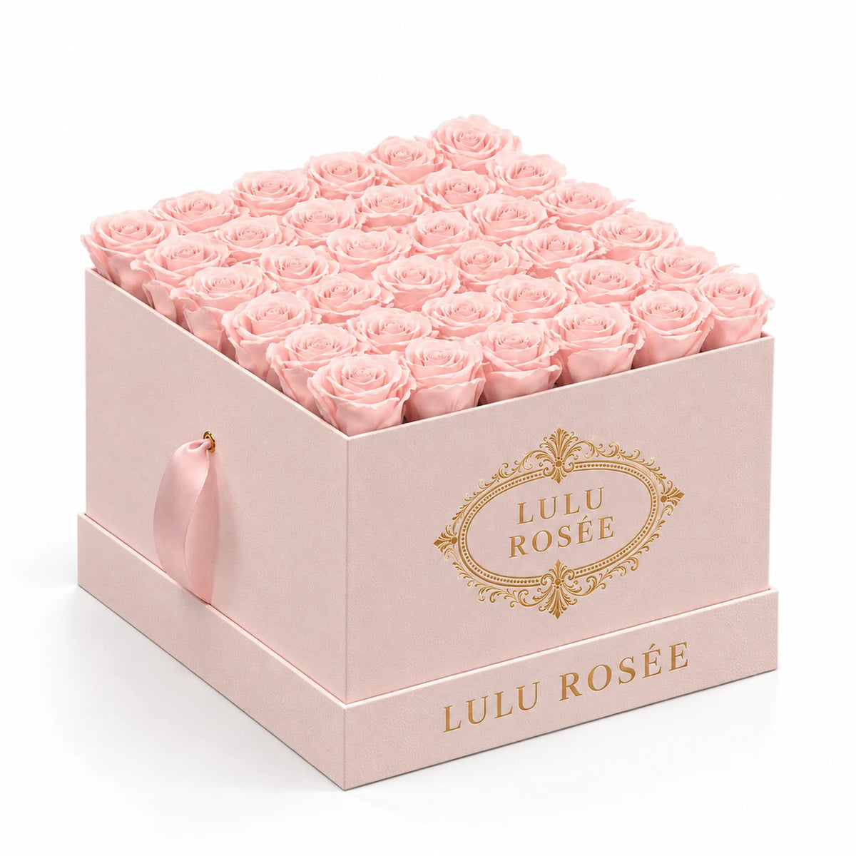 Blush preserved roses in a blush suede LULU ROSÉE large square box, photographed against a soft neutral backdrop.
