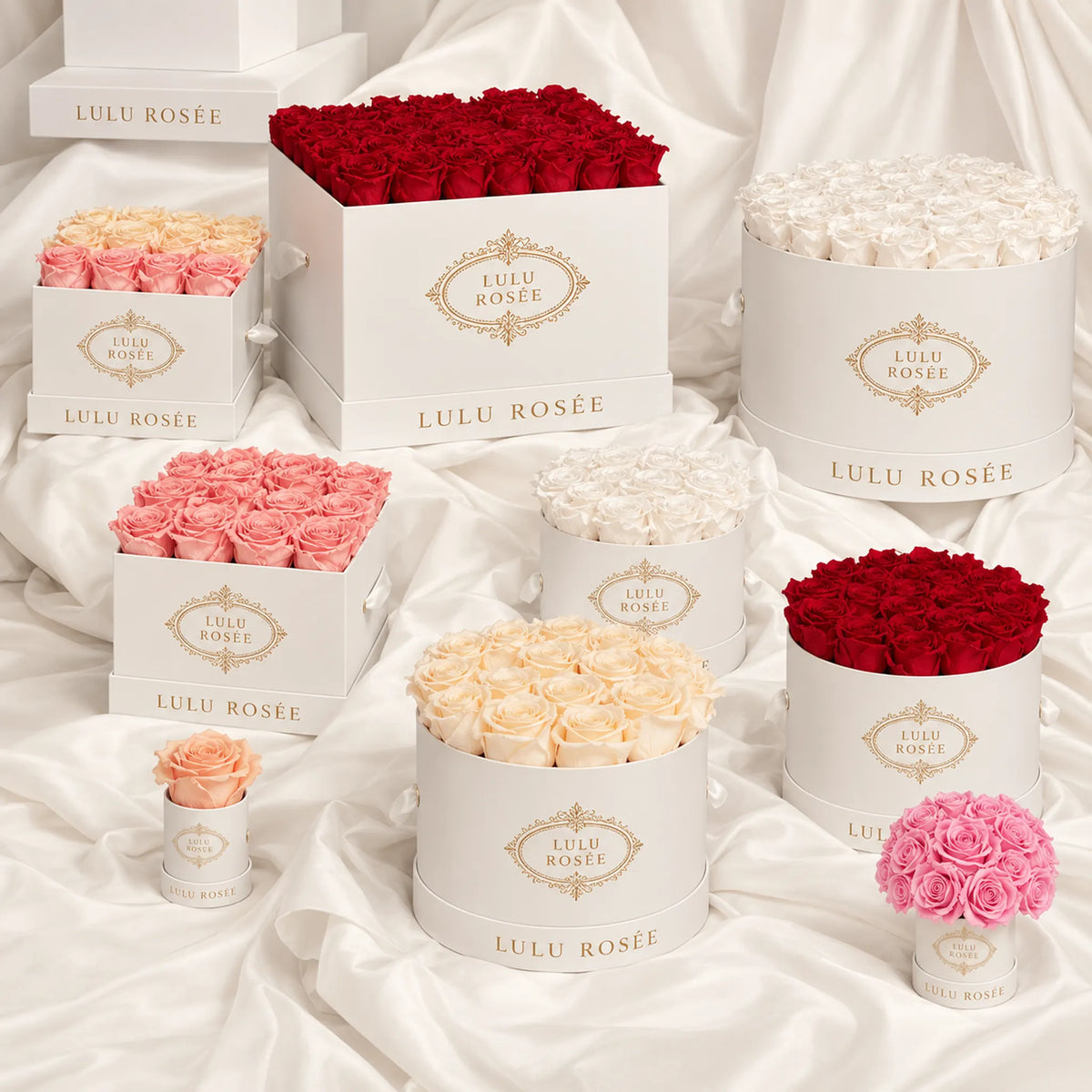 A collection of LULU ROSÉE preserved rose boxes in multiple colors and sizes, arranged together.