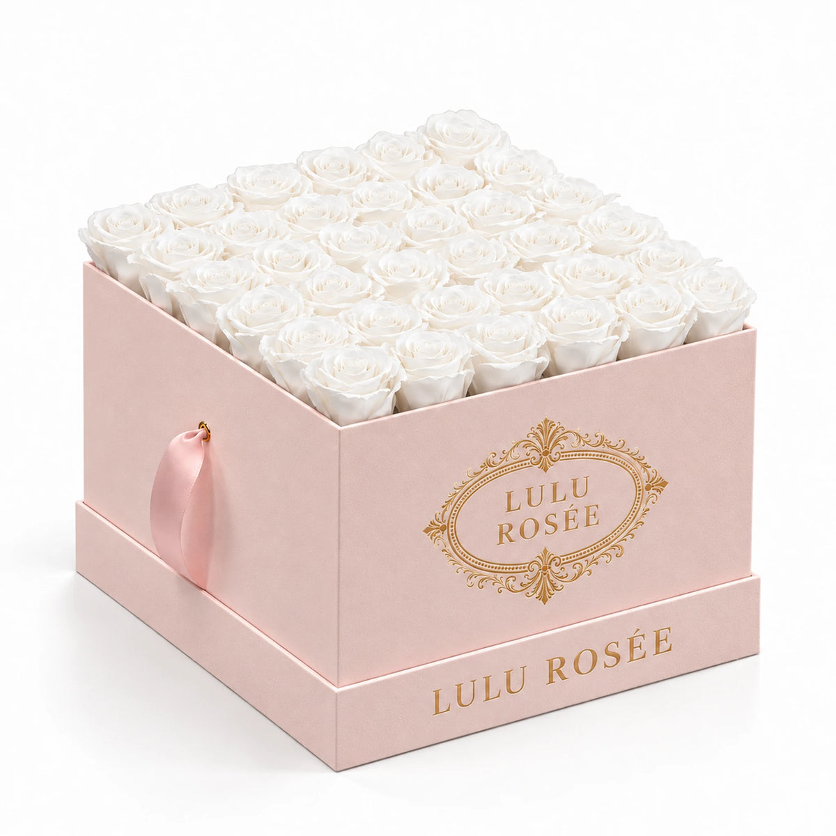White preserved roses fill a blush suede LULU ROSÉE large square box against a clean white background.