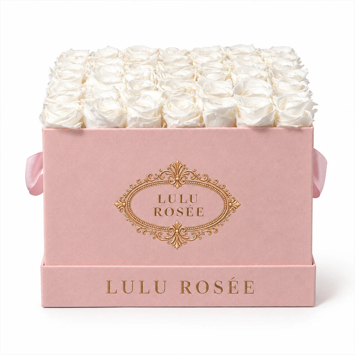 Front view of white preserved roses in a blush suede LULU ROSÉE large square box on a pale neutral backdrop.