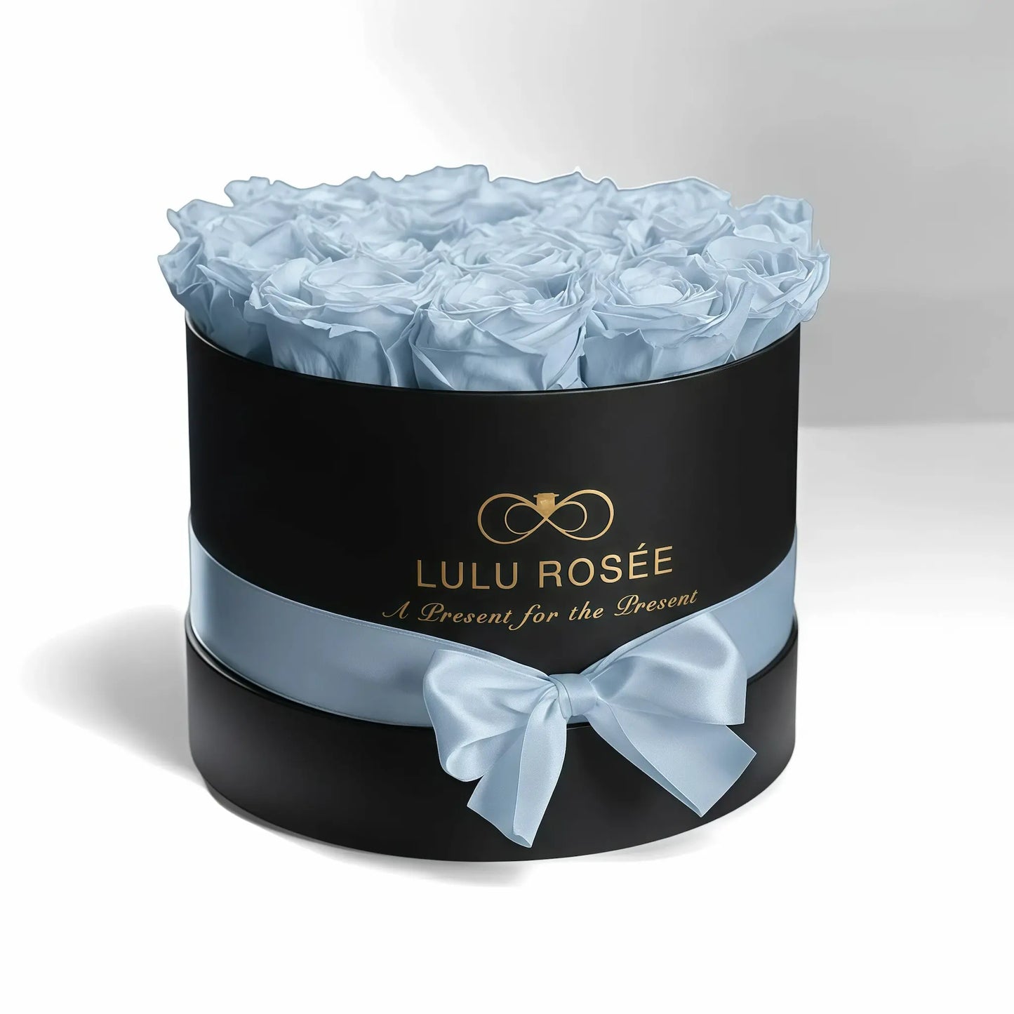 LULU ROSÉE medium round box baby blue roses black classic box on white background