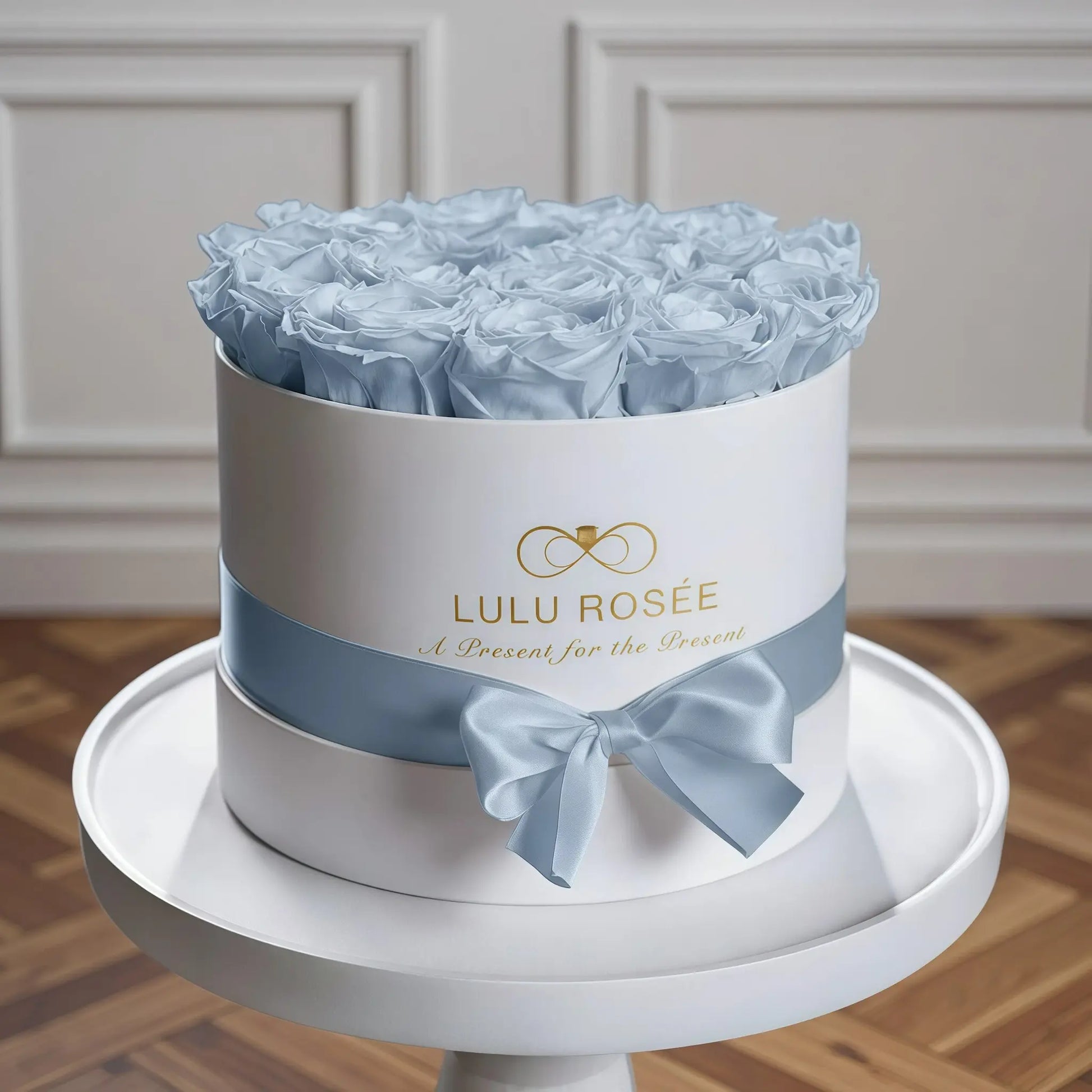 LULU ROSÉE medium round box baby blue roses white classic box in a cozy bedroom