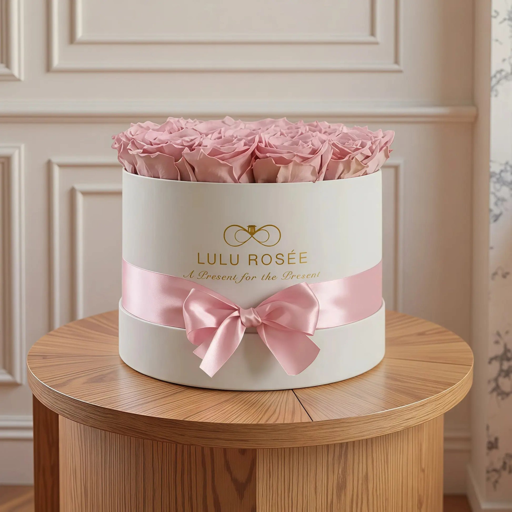 LULU ROSÉE medium round box light pink roses white classic box in a romantic bedroom