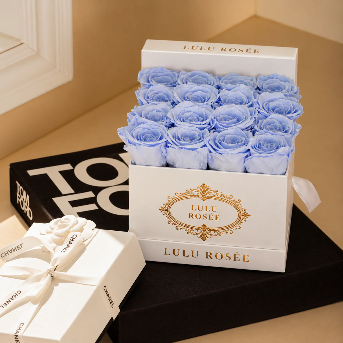 Baby blue preserved roses in a luxury LULU ROSÉE medium square box, gift detail.