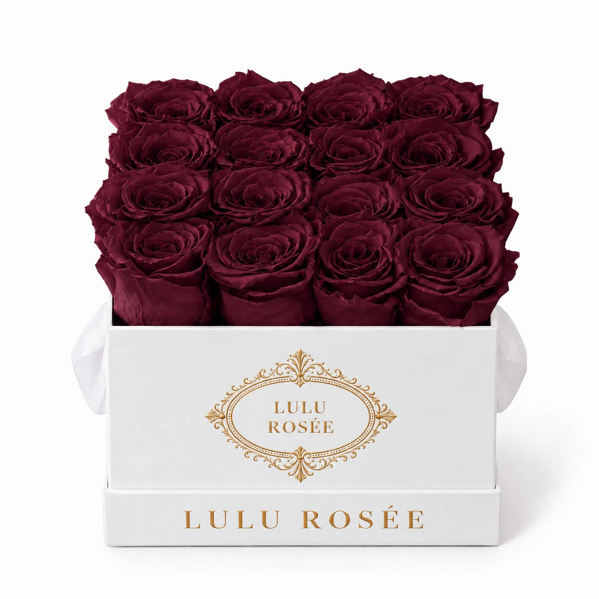 Burgundy preserved roses in a white classic LULU ROSÉE medium square box on a white background.