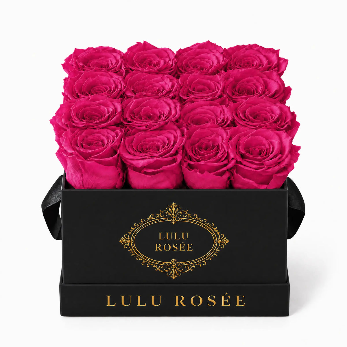 Hot pink preserved roses in a black classic LULU ROSÉE medium square box on a white background.