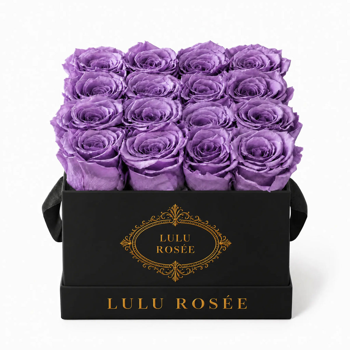 Lavender preserved roses in a black classic LULU ROSÉE medium square box on a white background.
