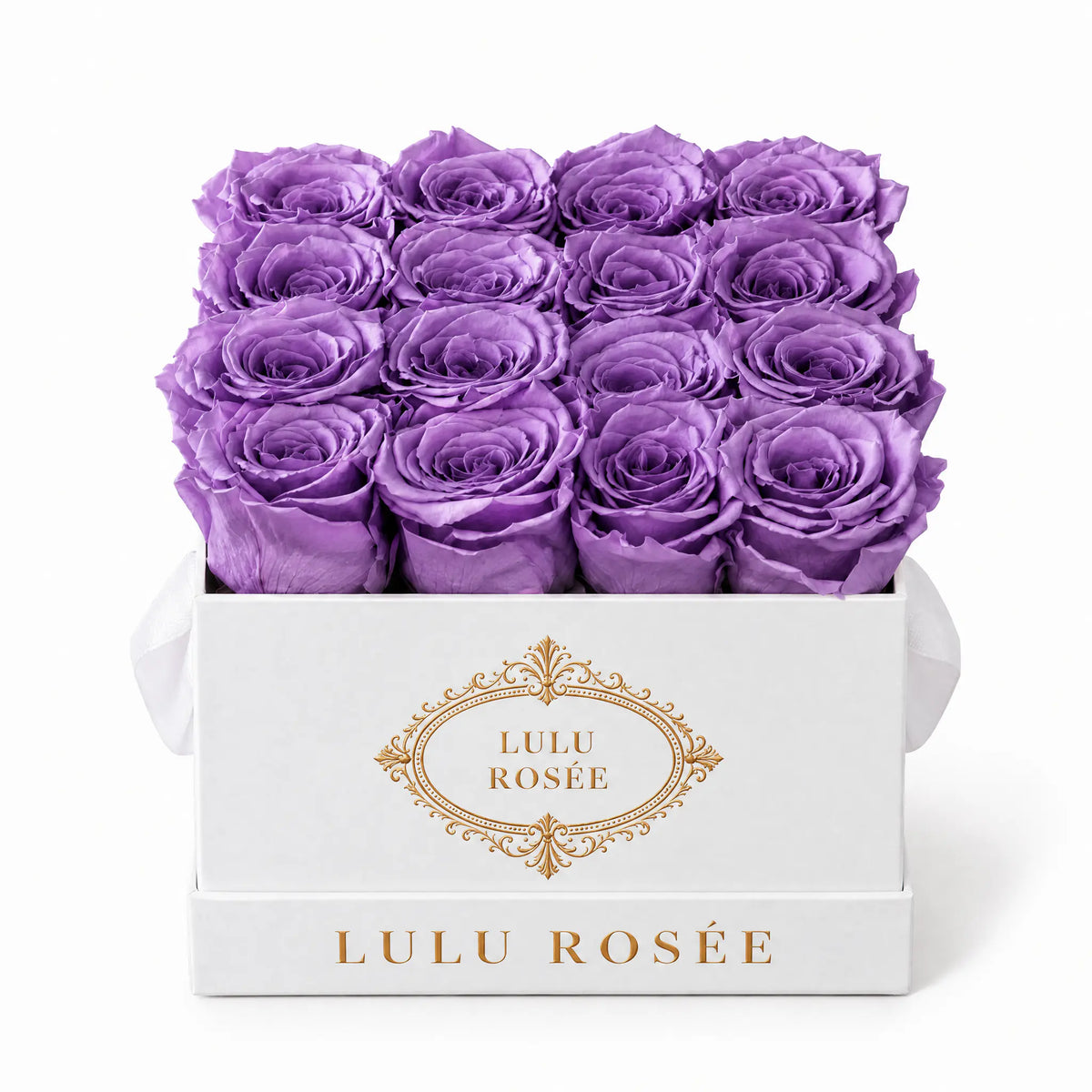 Lavender preserved roses in a white classic LULU ROSÉE medium square box on a white background.