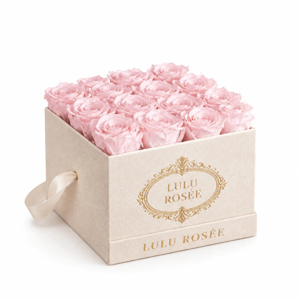 Light pink preserved roses in a blush suede LULU ROSÉE medium square box, suede angle.