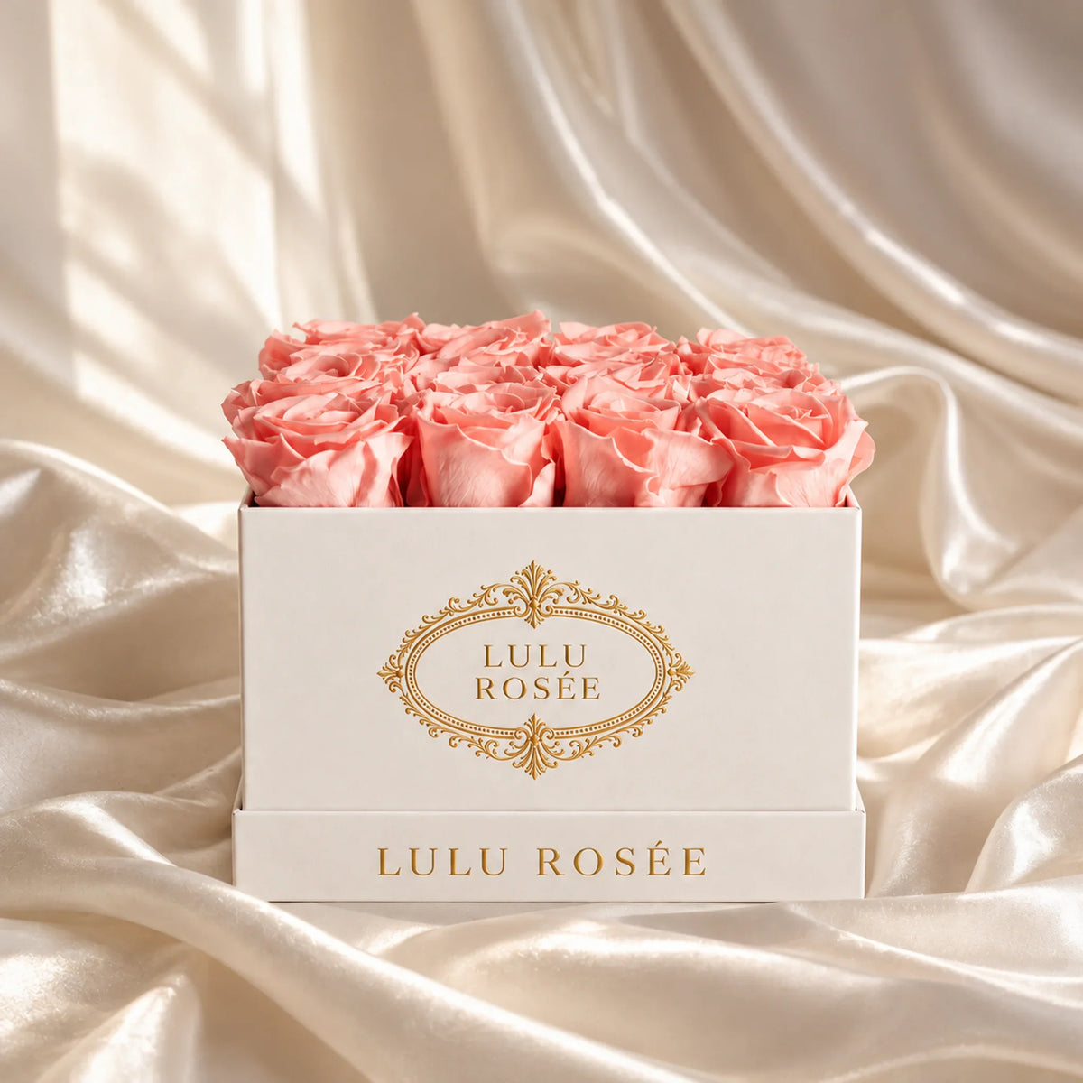 Light pink preserved roses in a luxury LULU ROSÉE medium square box, silk setting.