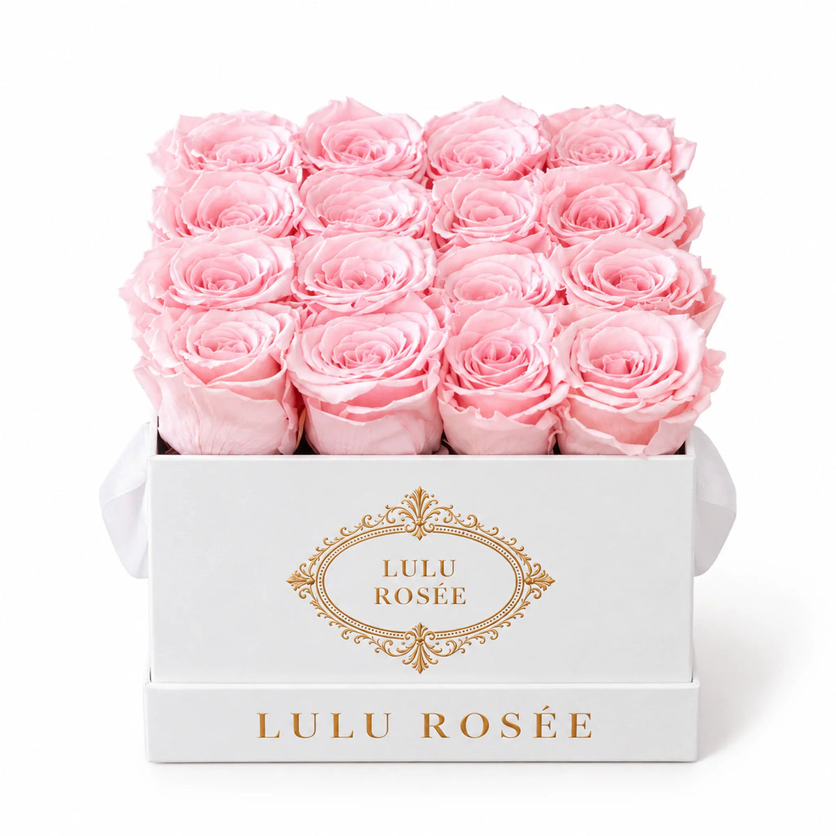 Light pink preserved roses in a white classic LULU ROSÉE medium square box on a white background.