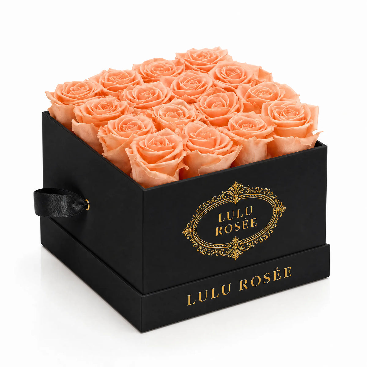 Orange preserved roses in a black classic LULU ROSÉE medium square box on a white background.