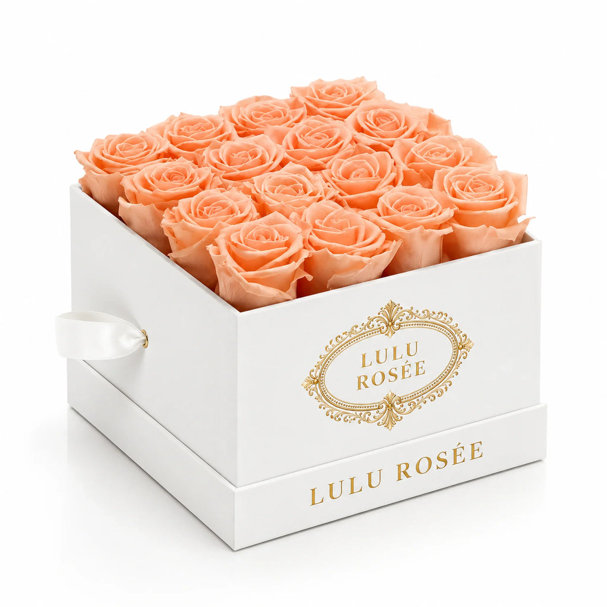 Orange preserved roses in a white classic LULU ROSÉE medium square box on a white background.