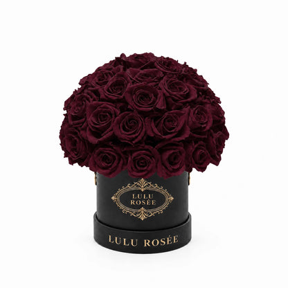 Burgundy eternal roses in a black classic Mini Le Plein box shown against a white background.