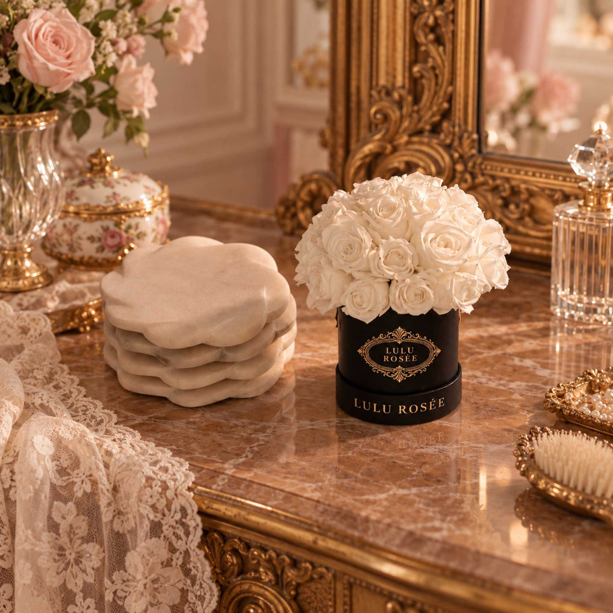 White eternal roses in a black classic Mini Le Plein box on an ornate vanity.