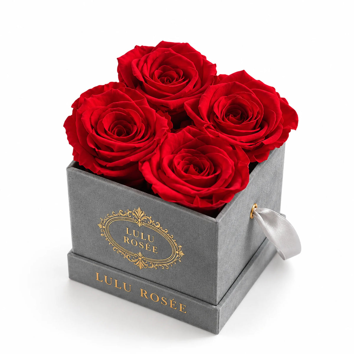 Front view of a grey suede box with four red preserved roses