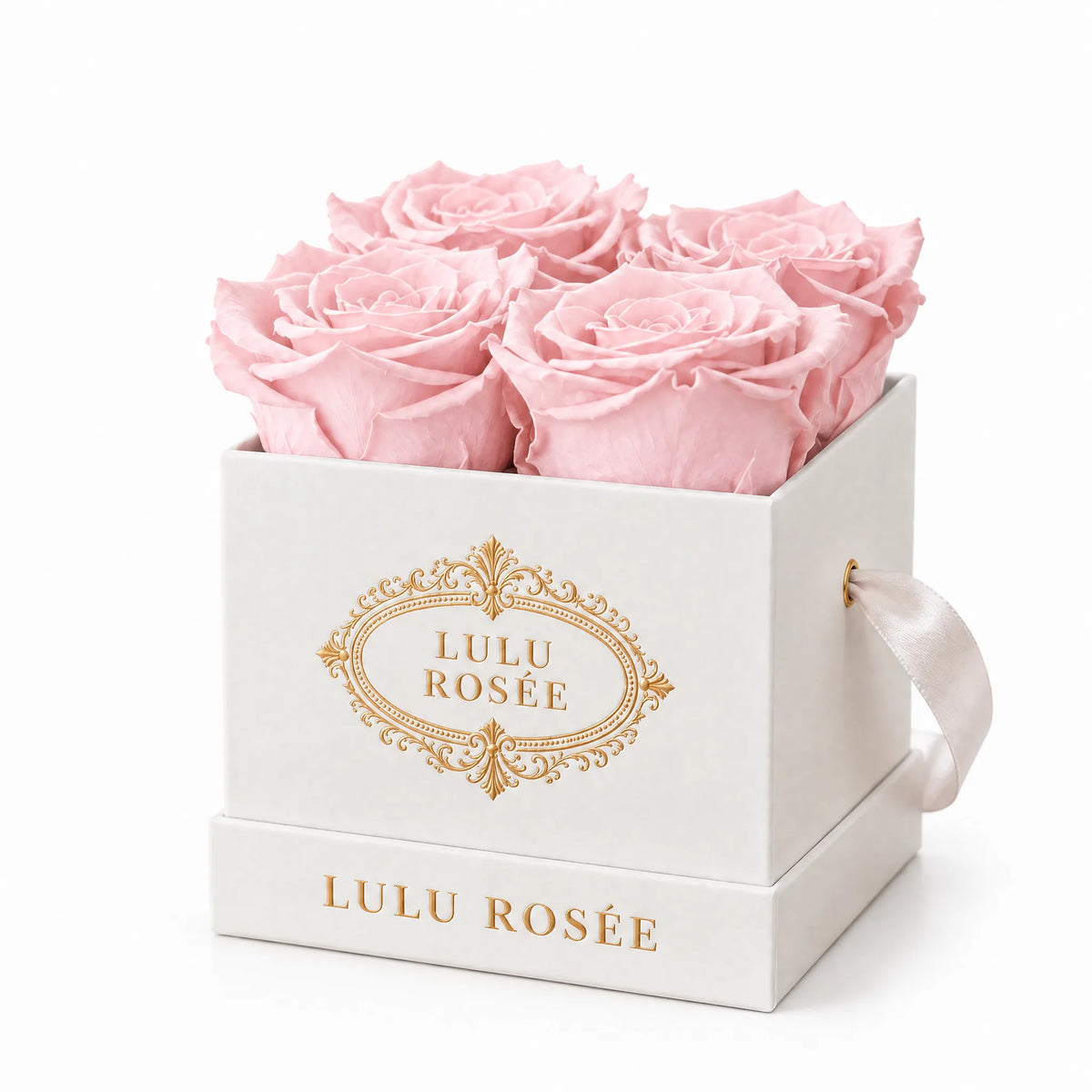 White classic box with four light pink preserved roses, on a white background