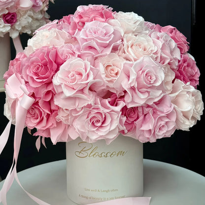 LULU ROSÉE Monochrome Pink Rose Garden Bucket, Preserved Rose Arrangement on White Marble Table