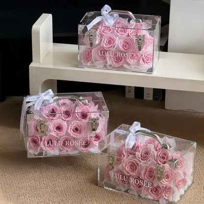 LULU ROSÉE Petite Eternal Acrylic Handbag Rose Box, small transparent acrylic handbag-shaped gift box filled with blush pink preserved roses, three boxes minimalist shelf styling display, customizable flower color options, mini luxury everlasting floral souvenir for birthday, anniversary & romantic gift giving