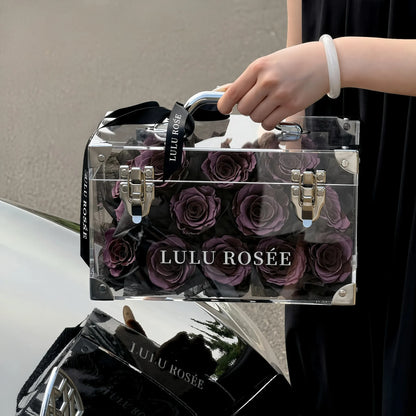 lulu-rosee-petite-eternal-acrylic-handbag-rose-box-dark-purple-black-ribbon-dark-background.webp