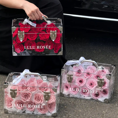 LULU ROSÉE Petite Eternal Acrylic Handbag Rose Box, small transparent acrylic handbag-shaped gift box, wine red & blush pink two box matching set shot beside car, customizable flower color options, mini luxury everlasting floral souvenir for birthday, anniversary & romantic gift giving