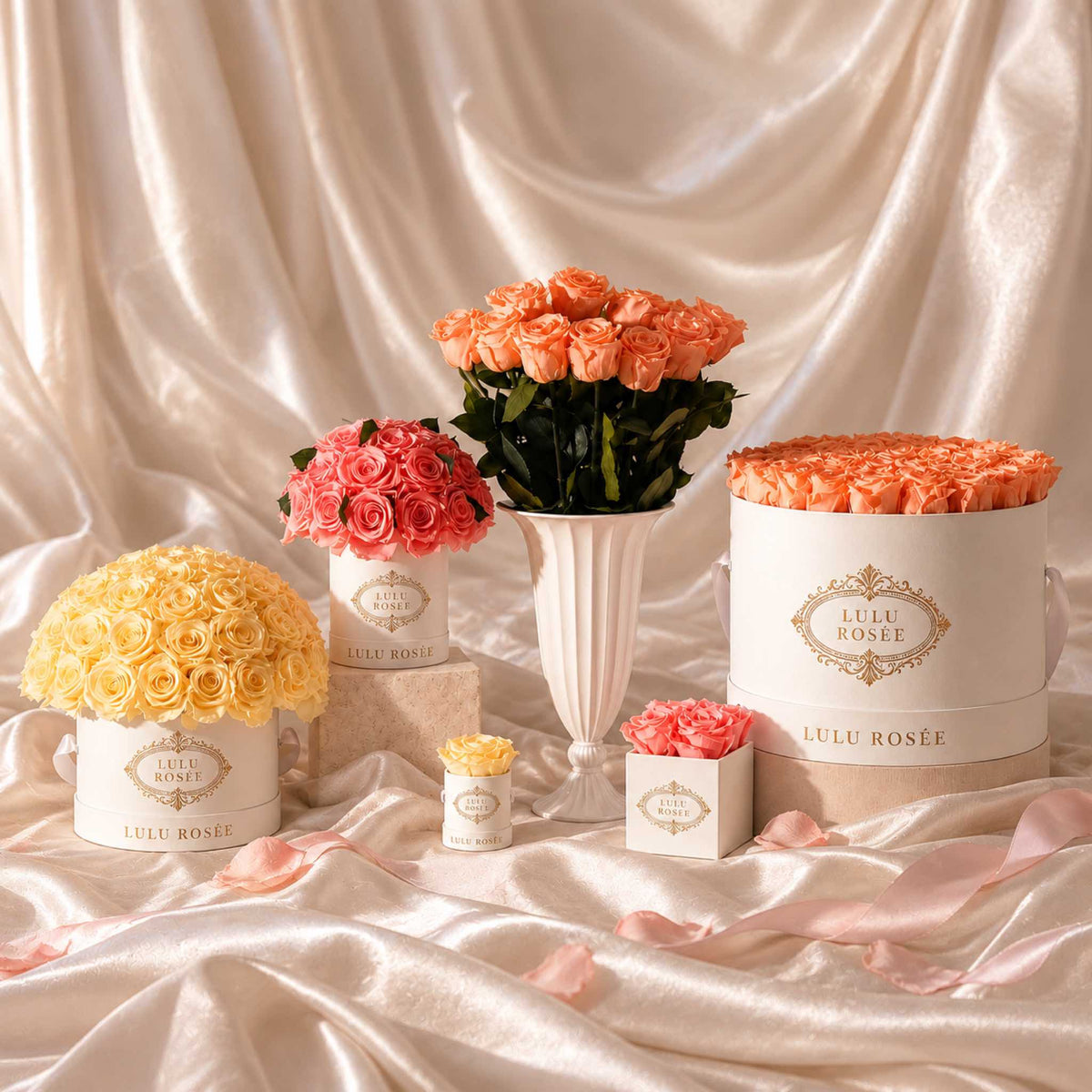 LULU ROSÉE Small Le Plein preserved rose arrangements styled on softly draped silk.