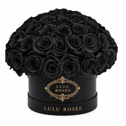 Black preserved roses in a black classic Small Le Plein box on a white background.