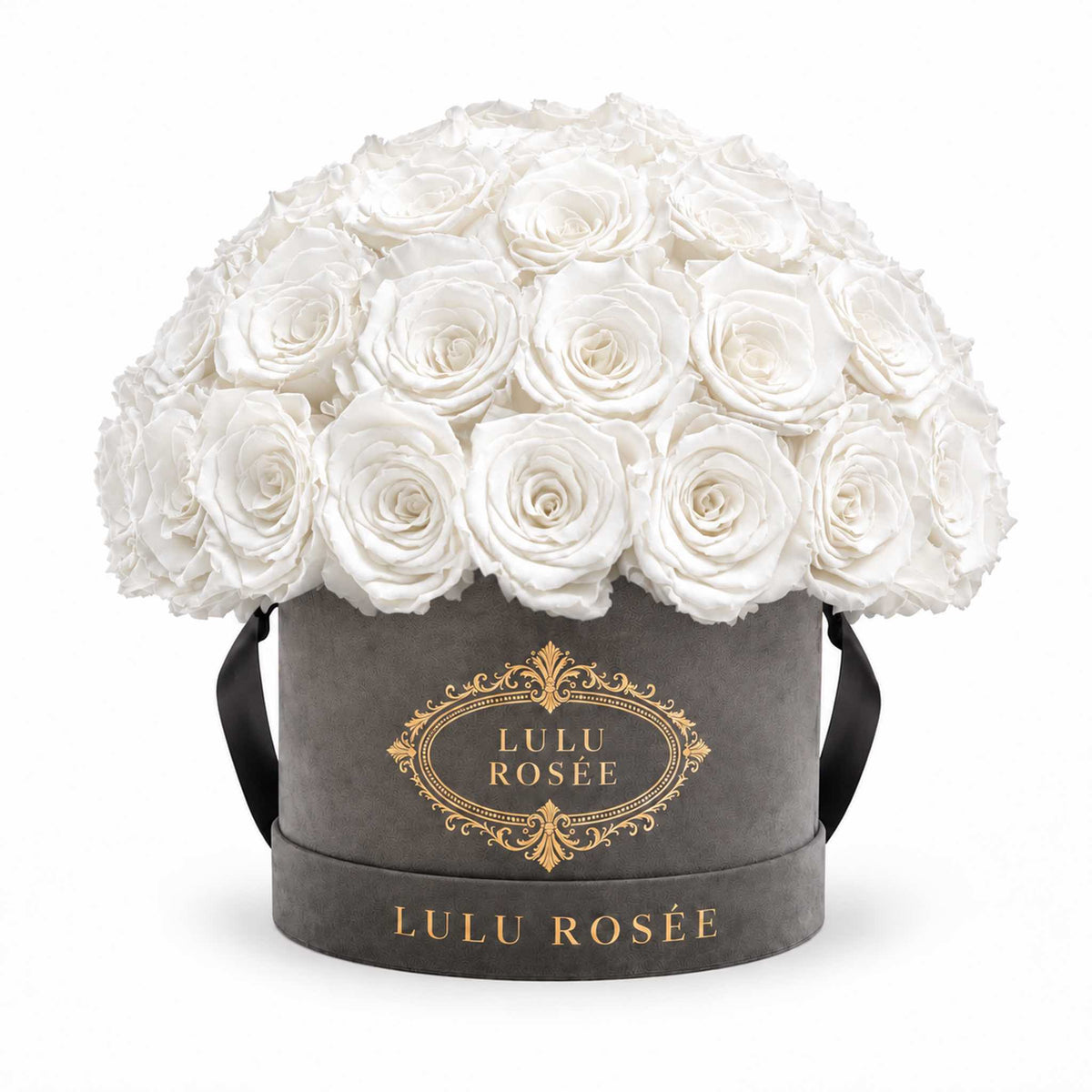 White preserved roses in a grey suede Small Le Plein box on a white background.
