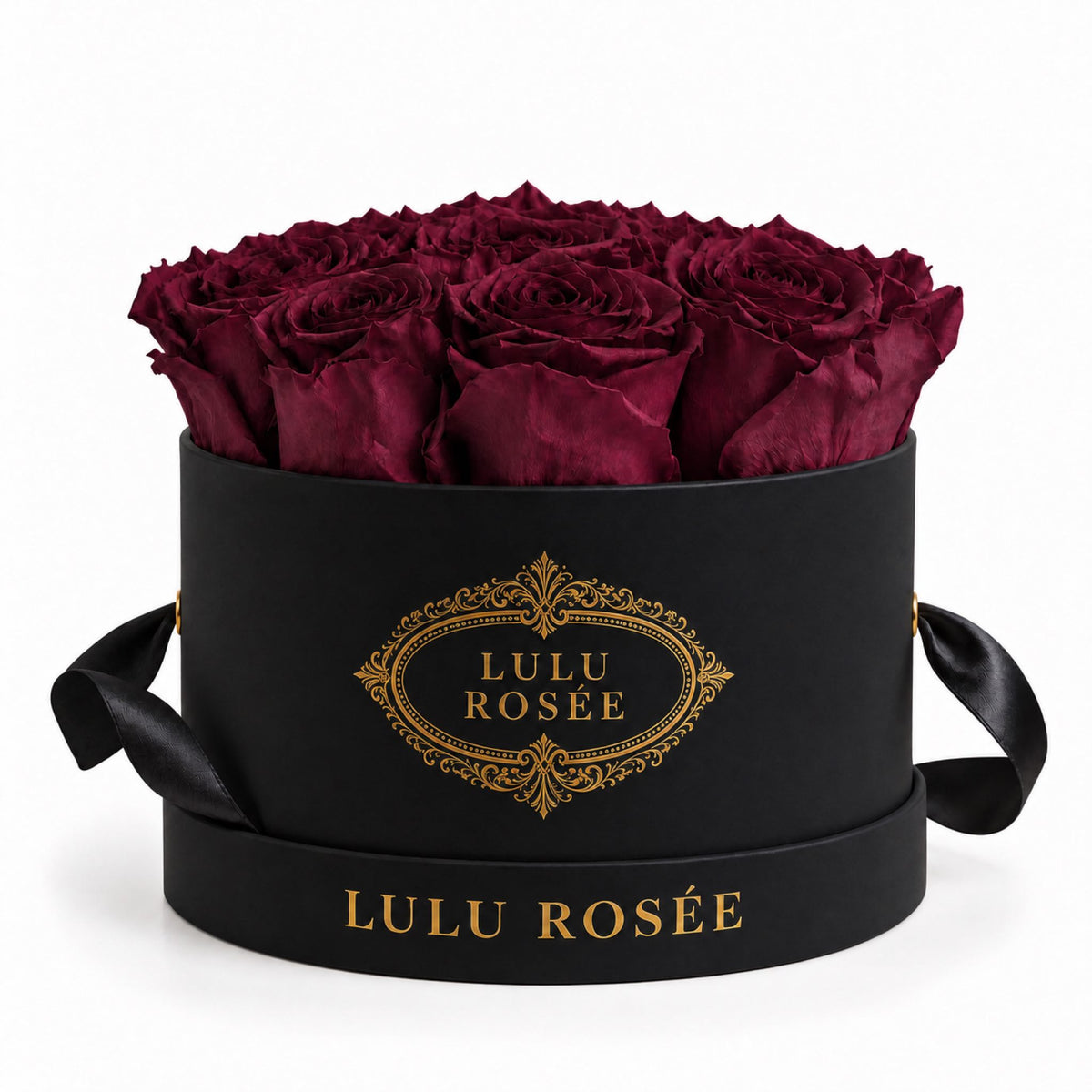 Burgundy preserved roses in a black round box with a black ribbon.