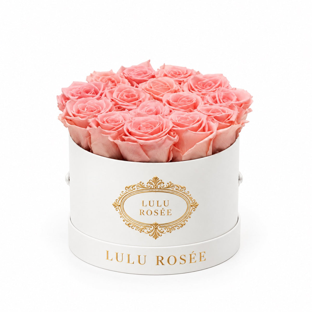 Light pink preserved roses in a white round box with a gold LULU ROSÉE logo.