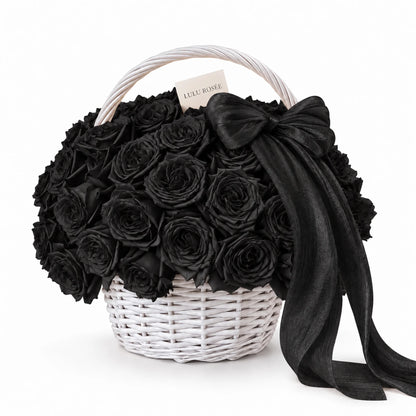Black preserved rose basket with a black bow and white handle