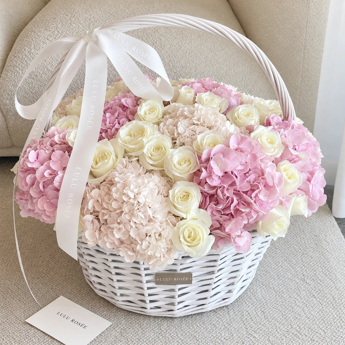 Blush preserved hydrangea and rose basket displayed beside a LULU ROSÉE card