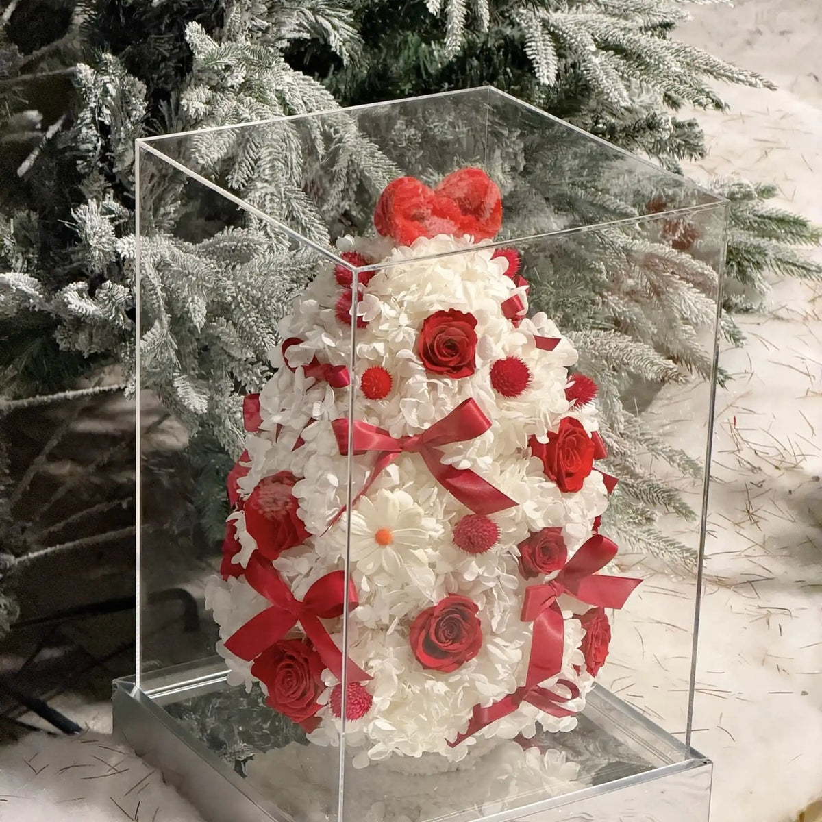 Preserved hydrangea Christmas tree shown in a clear display box with a reflective base.