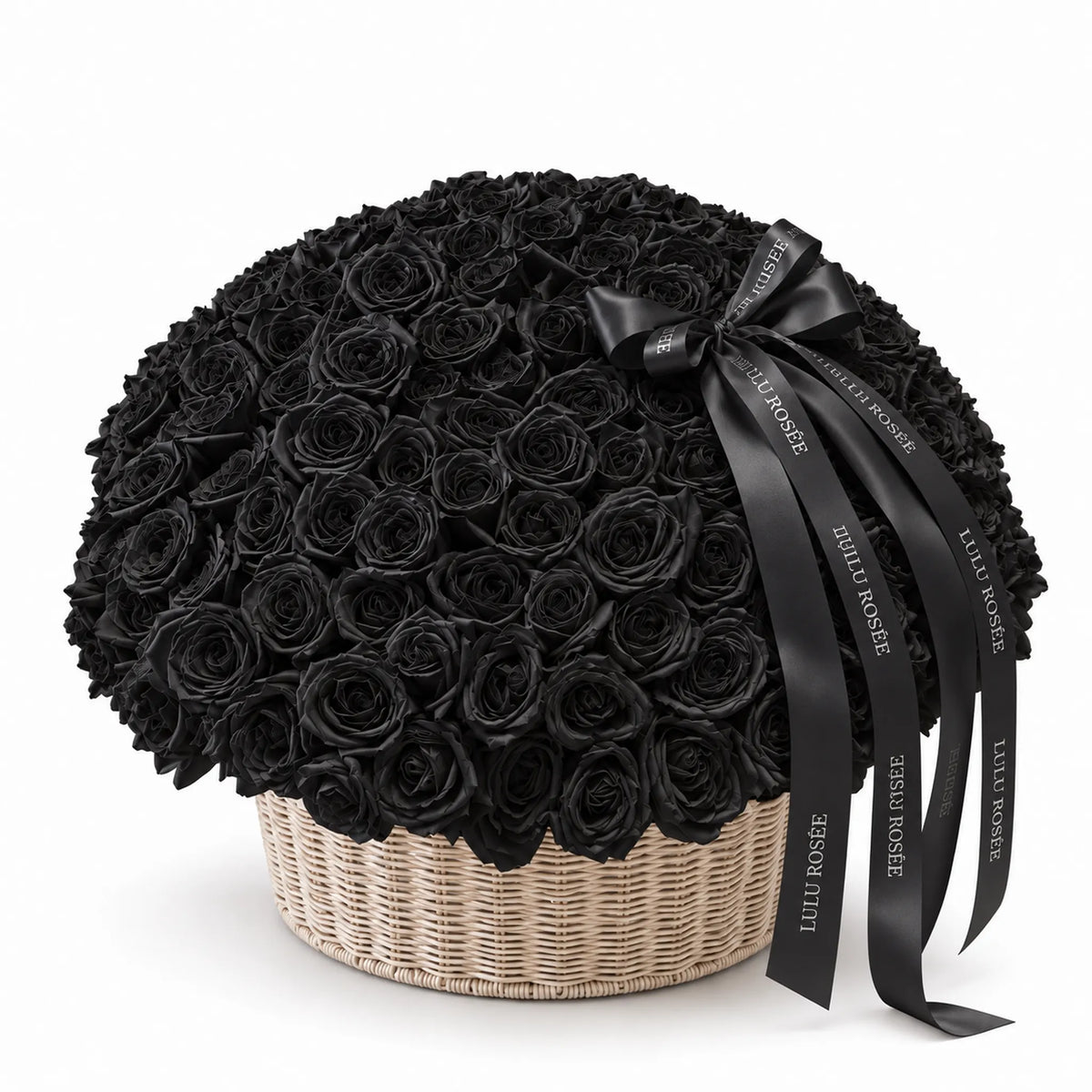 Black preserved roses in a round basket with a flowing black bow