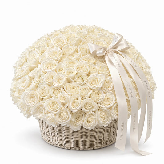 Cream preserved roses in a large round basket with a flowing white bow