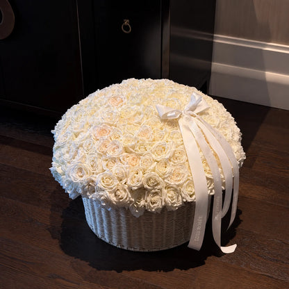 Large cream preserved rose basket in a dimly lit room