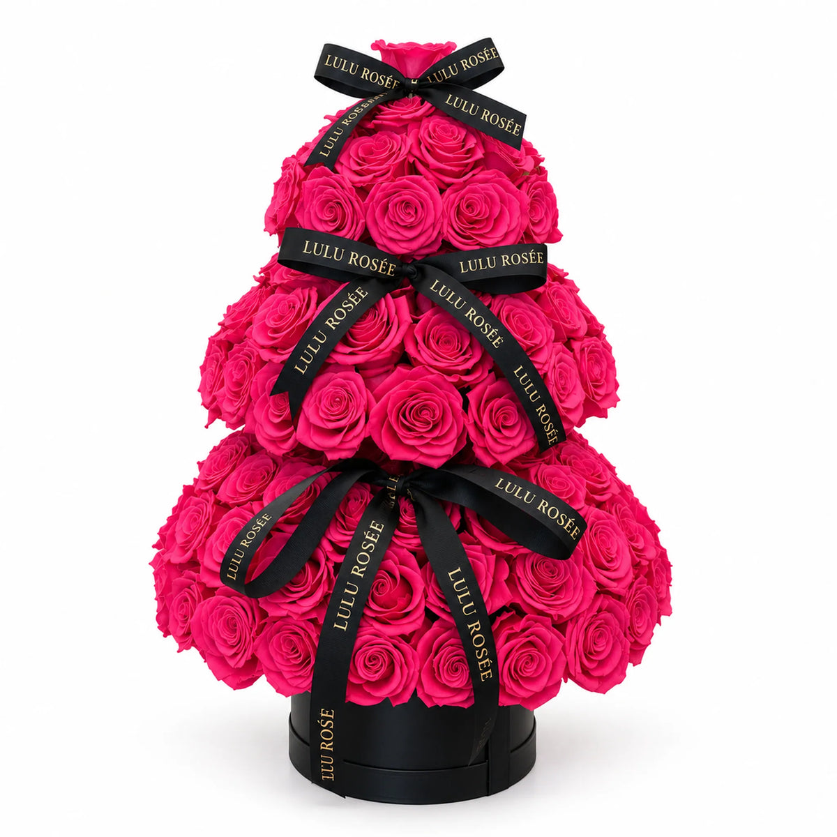 Hot pink preserved rose tree with black signature ribbons against a white background
