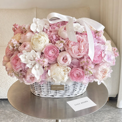 Preserved peony and hydrangea basket displayed on a table beside a LULU ROSÉE card