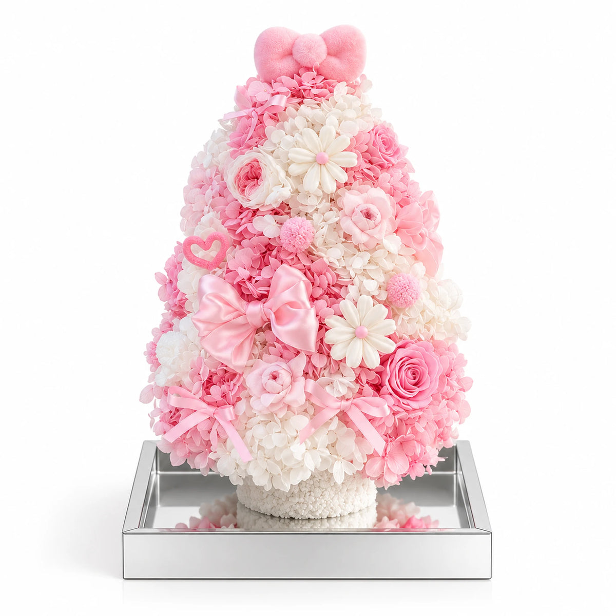 Pink and white preserved hydrangea Christmas tree with roses and a pink bow on a white background.